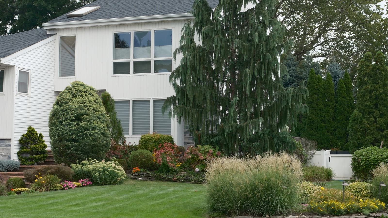A large maintained property with mature trees and open lawn